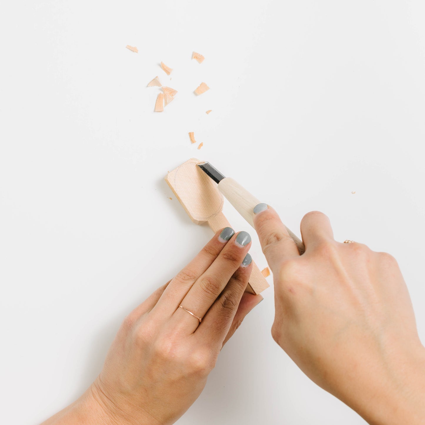 Spoon blank being carved with the spoon gouge tool included in the kit.