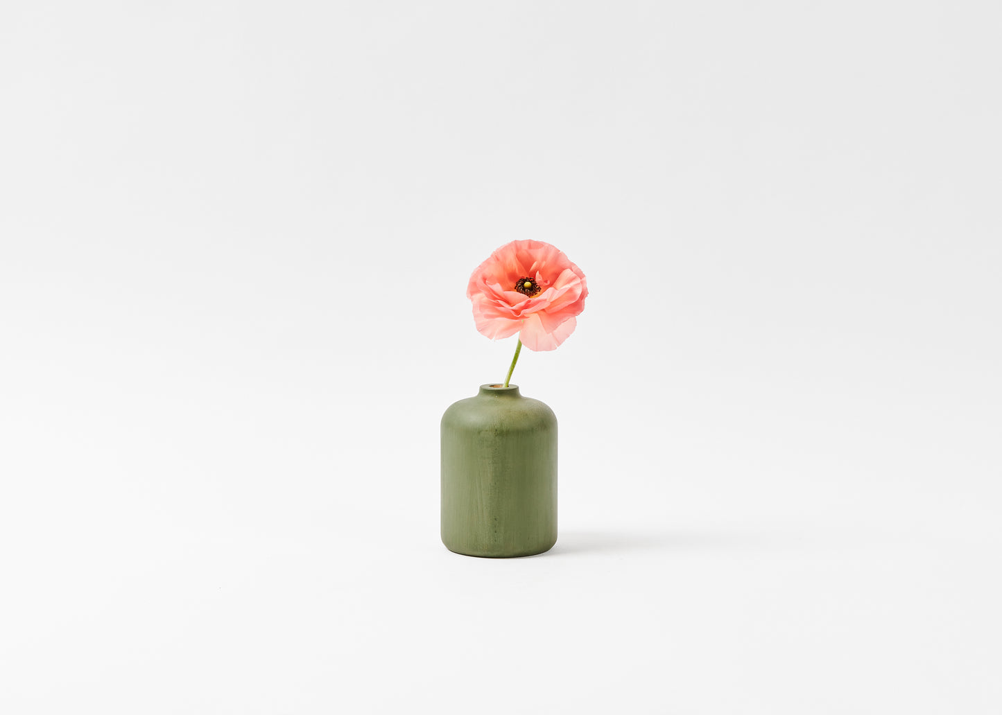 Bud vase sage green with pink flower. By Melanie Abrantes Designs.
