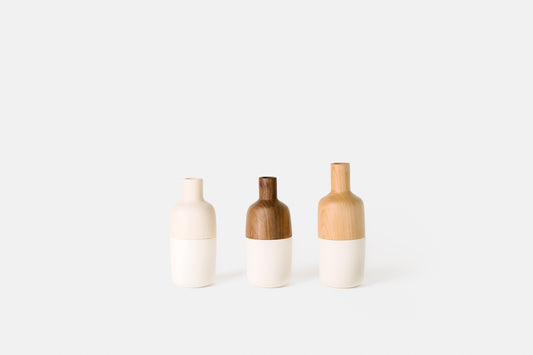 Hardwood and white ceramic marais vases by Melanie Abrantes Designs.