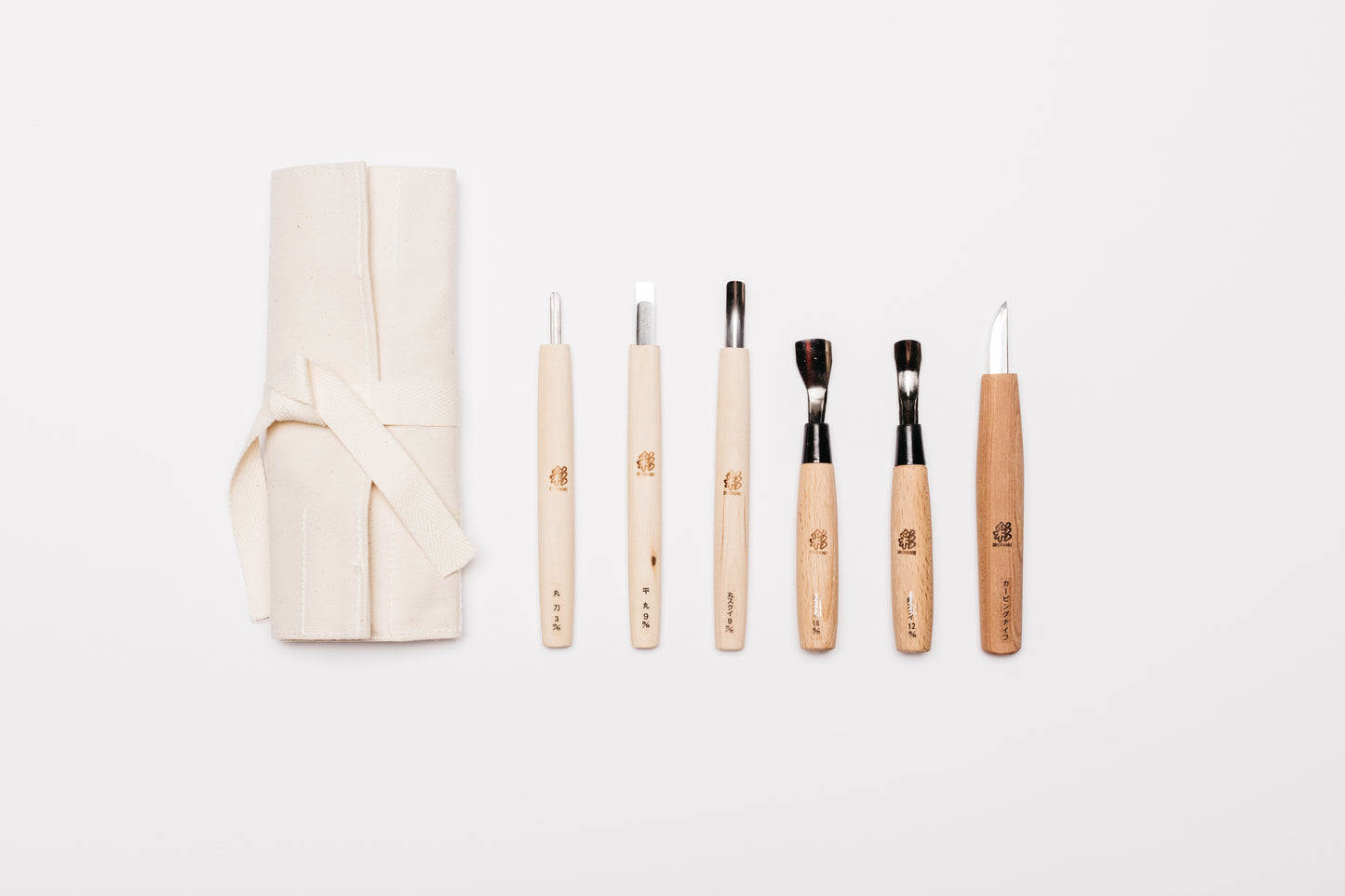 Aerial view of the tool roll and carving tools included in the carving kit.