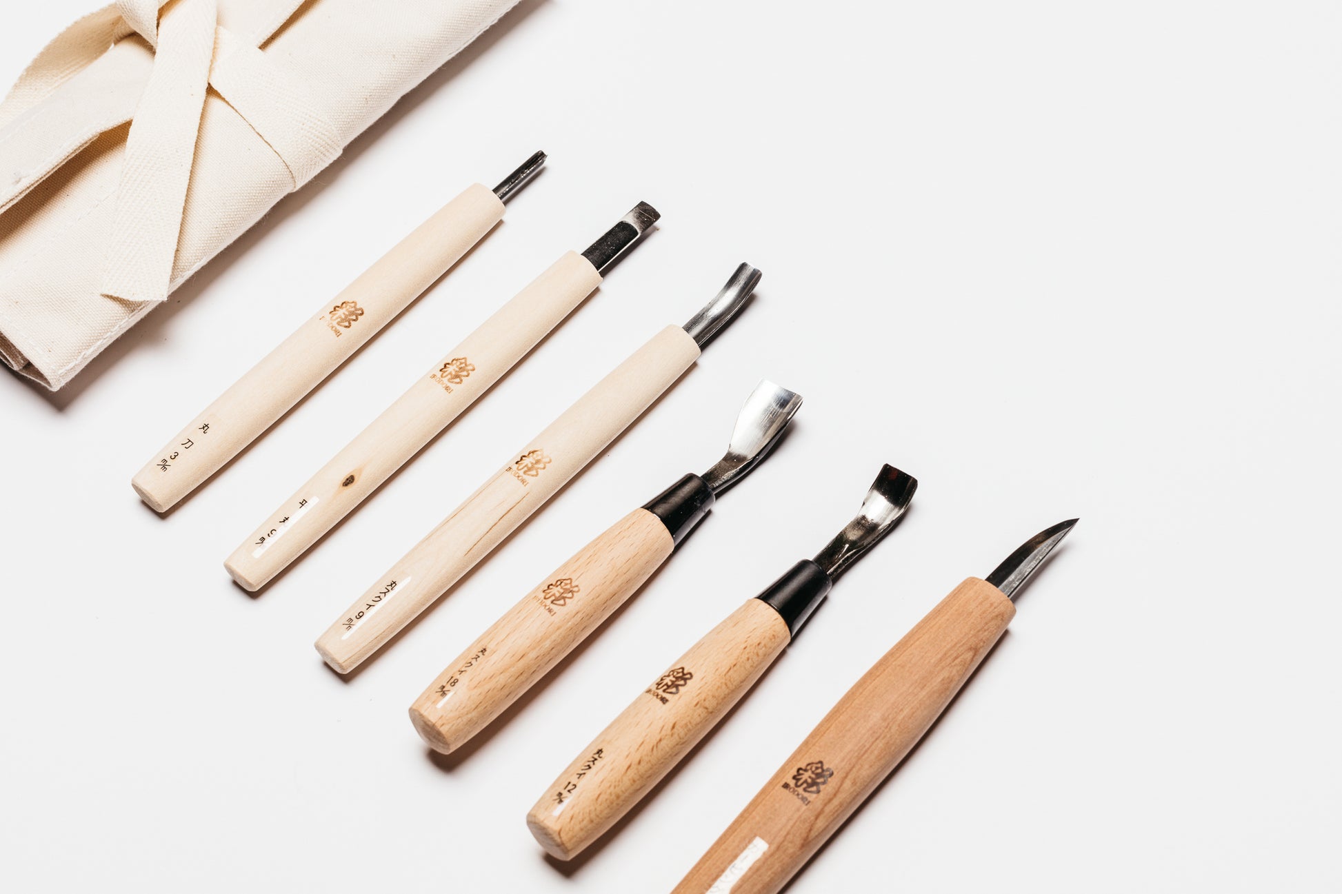 Close up view of the tool roll and all six of the carving tools you will get in the Bowl Carving Tool Set.