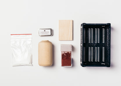 Items included in the Tie-Dye Kit. Fixer, wood butter, vase, wood sample, pigment and dye basket.