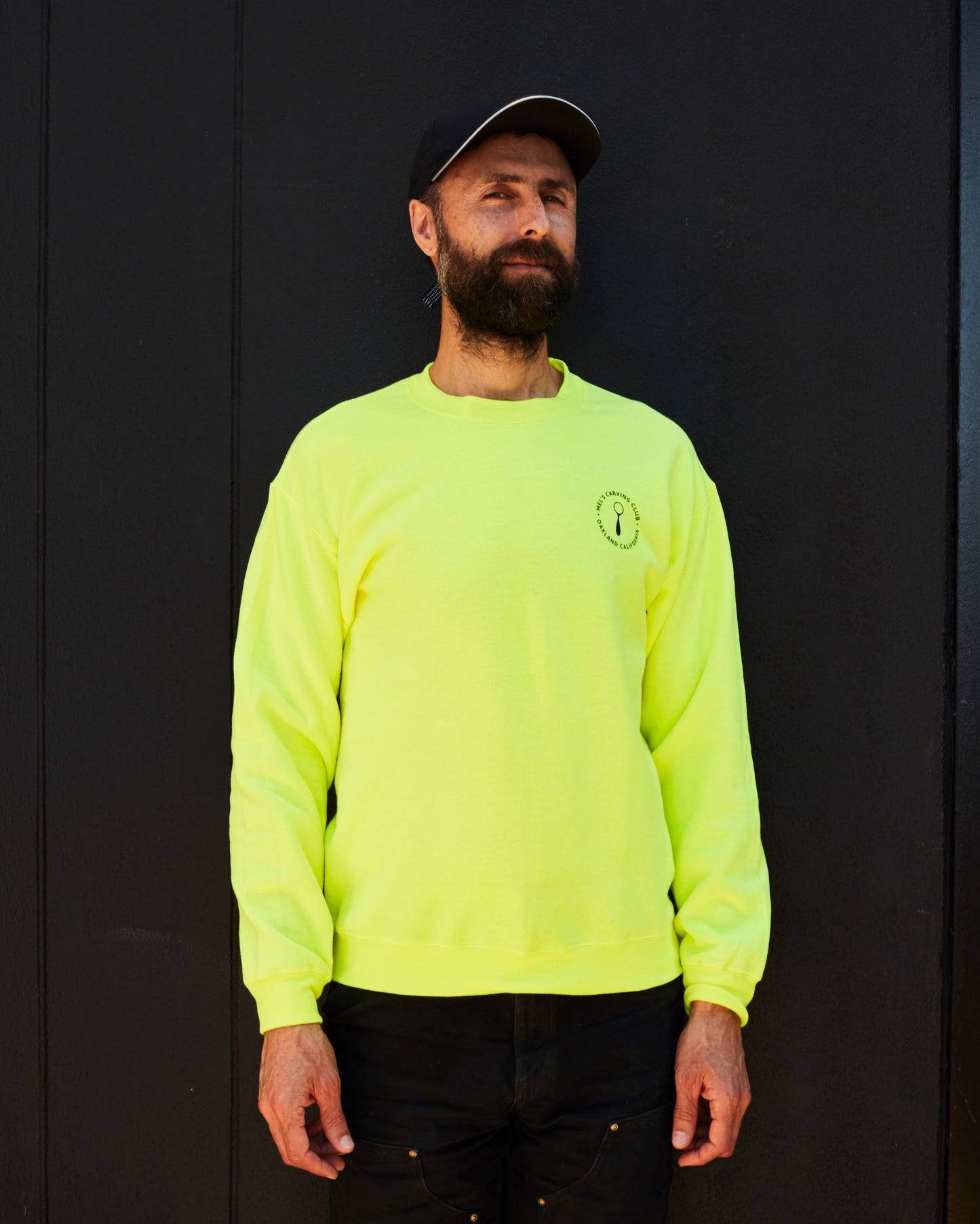 Person wearing Neon Yellow Mel's Carving Club Sweatshirt with Logo on Chest | Melanie Abrantes Designs