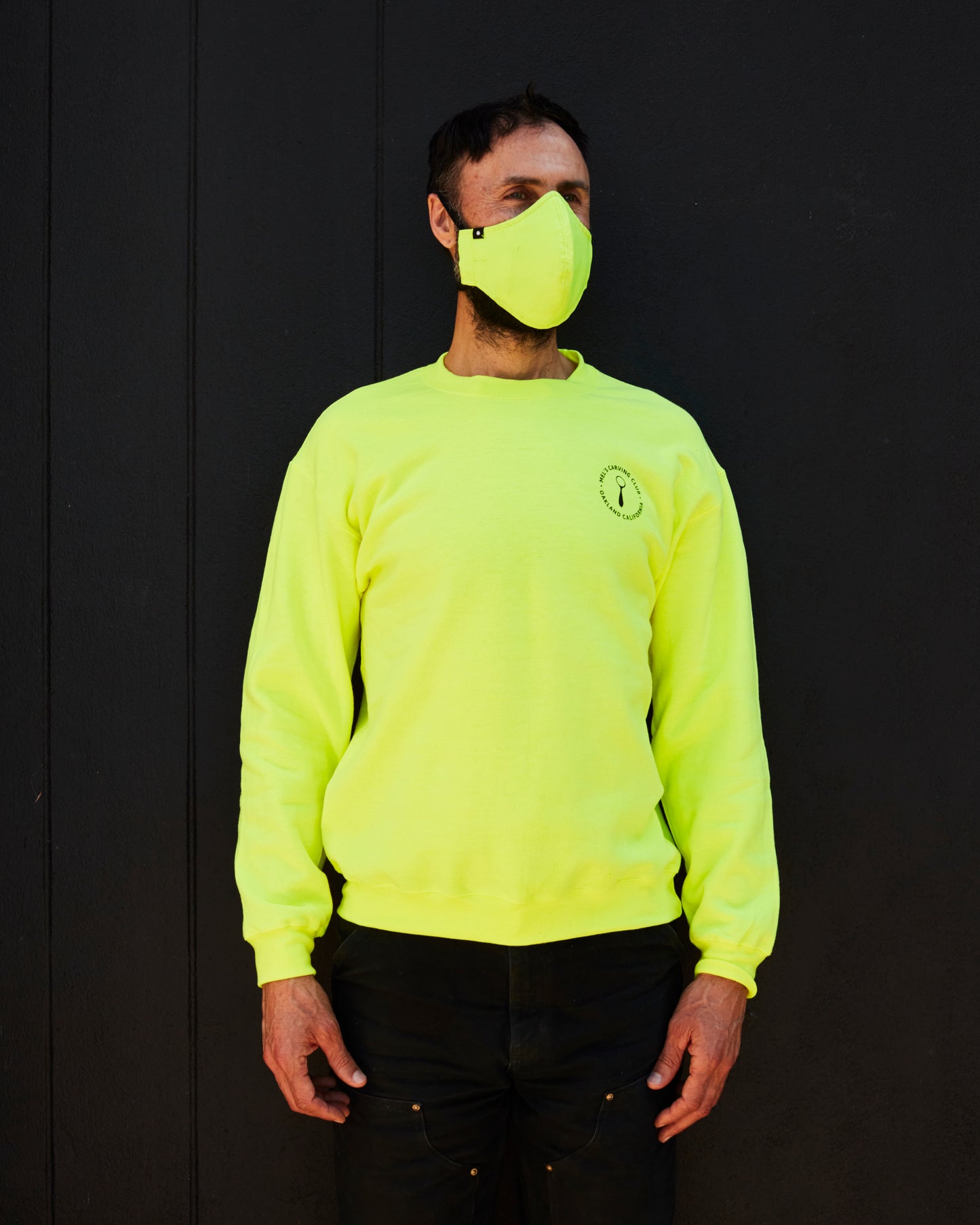 Person wearing Neon Yellow Mel's Carving Club Sweatshirt with Logo on Chest | Melanie Abrantes Designs