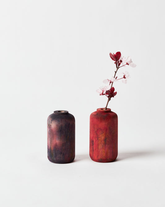 Left to Right: Midnight maple bud vase, Crimson maple bud vase holding plum blossom.