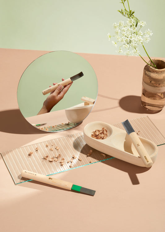 The three bowl tools are laid out creatively on a light pink table. The Ruth Marais Vase placed in the back with a flower in it. By Melanie Abrantes Designs