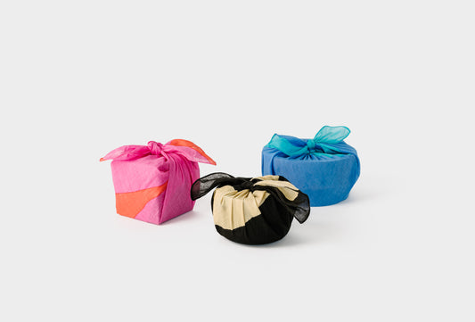 Furoshiki Reusable Gift Wrapping Cloth. Three colors shown wrapped. 