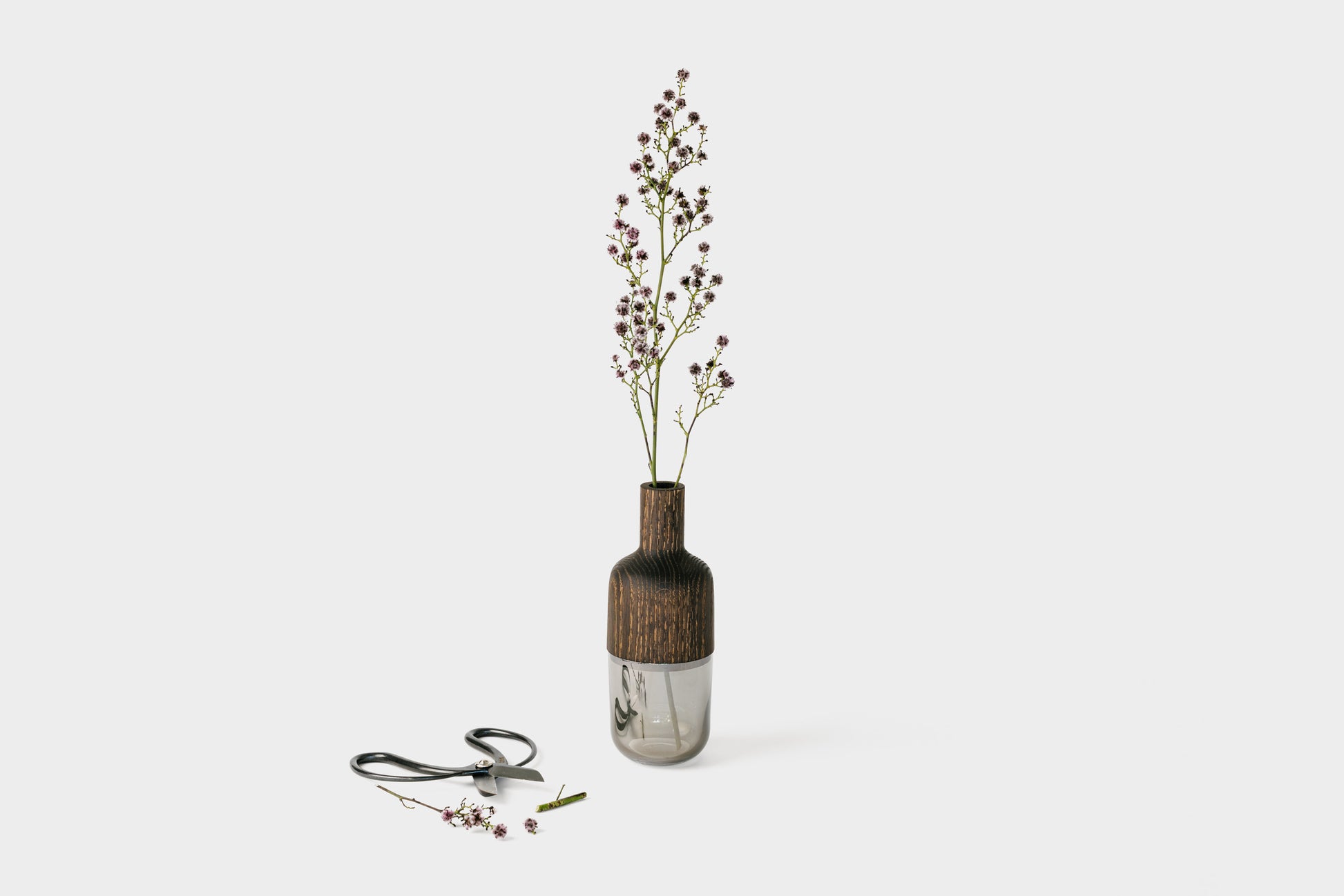 Japanese floral shears are shown with our Mae Marais Vase. Flowers in the vase with the cuttings next to the shears. Vase by Melanie Abrantes Designs.