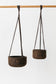 Large and small hand-turned charcoal cork planters shown hung.