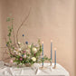 Tapered Candles in Heron sitting on a table with a flower arrangement | By The Floral Society