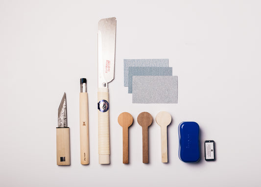 Deluxe spoon carving kit includes carving knife, spoon gouge, mini panel z-saw, cherry, walnut, and bass spoon blanks, first-aid, wood butter, and 3 sandpaper grits.