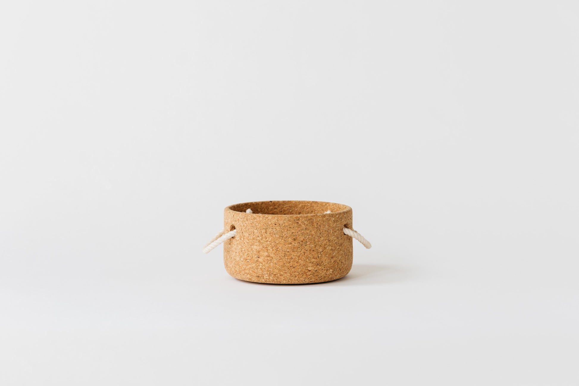 Small cork bowl with two rope handles. Hand-turned in Oakland Ca.  By Melanie Abrantes Designs.