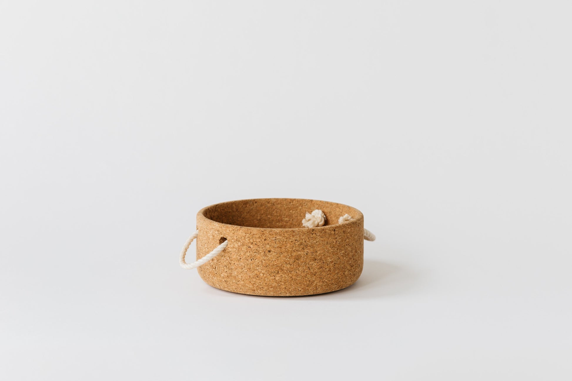 Large cork bowl with natural rope handles. Profile of the bowl is wide and low.