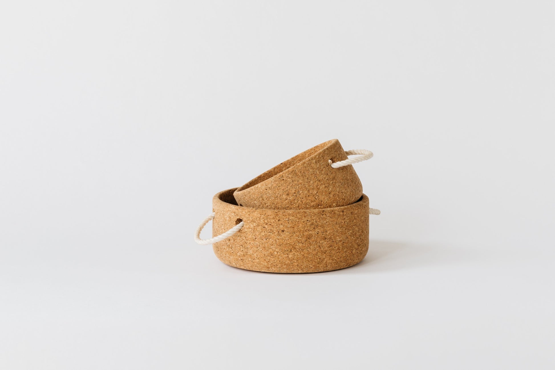 Small cork bowl placed in the large cork bowl on a tilt. By Melanie Abrantes Designs.