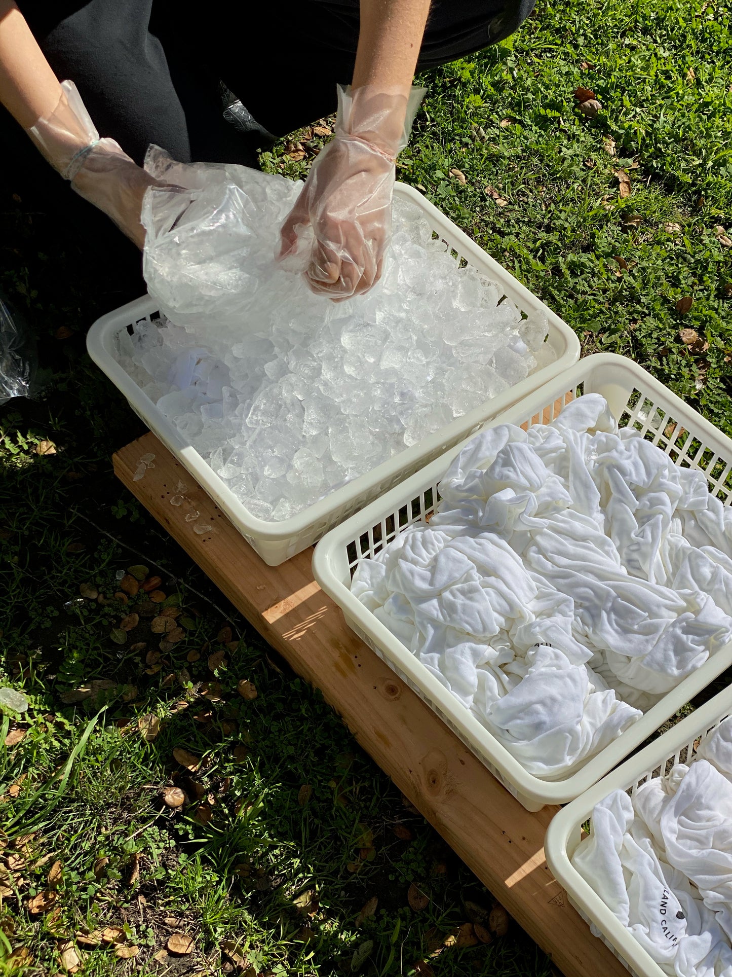 Trays filled with ice showing dye process for sweatshirts