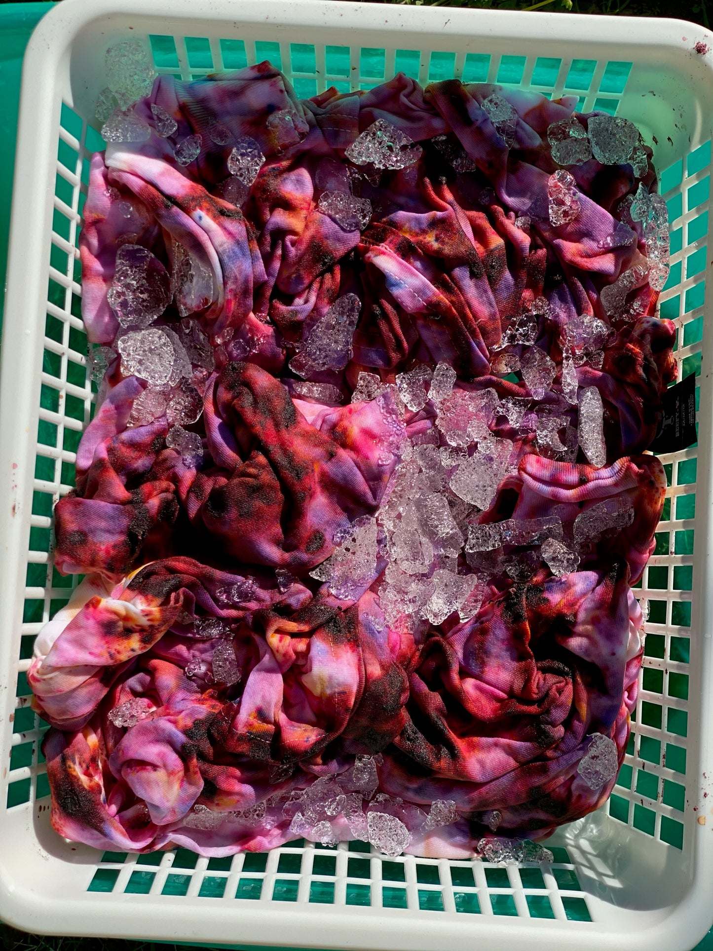 Tray, ice and fabric showing unique dye process for tie-dye sweatshirts