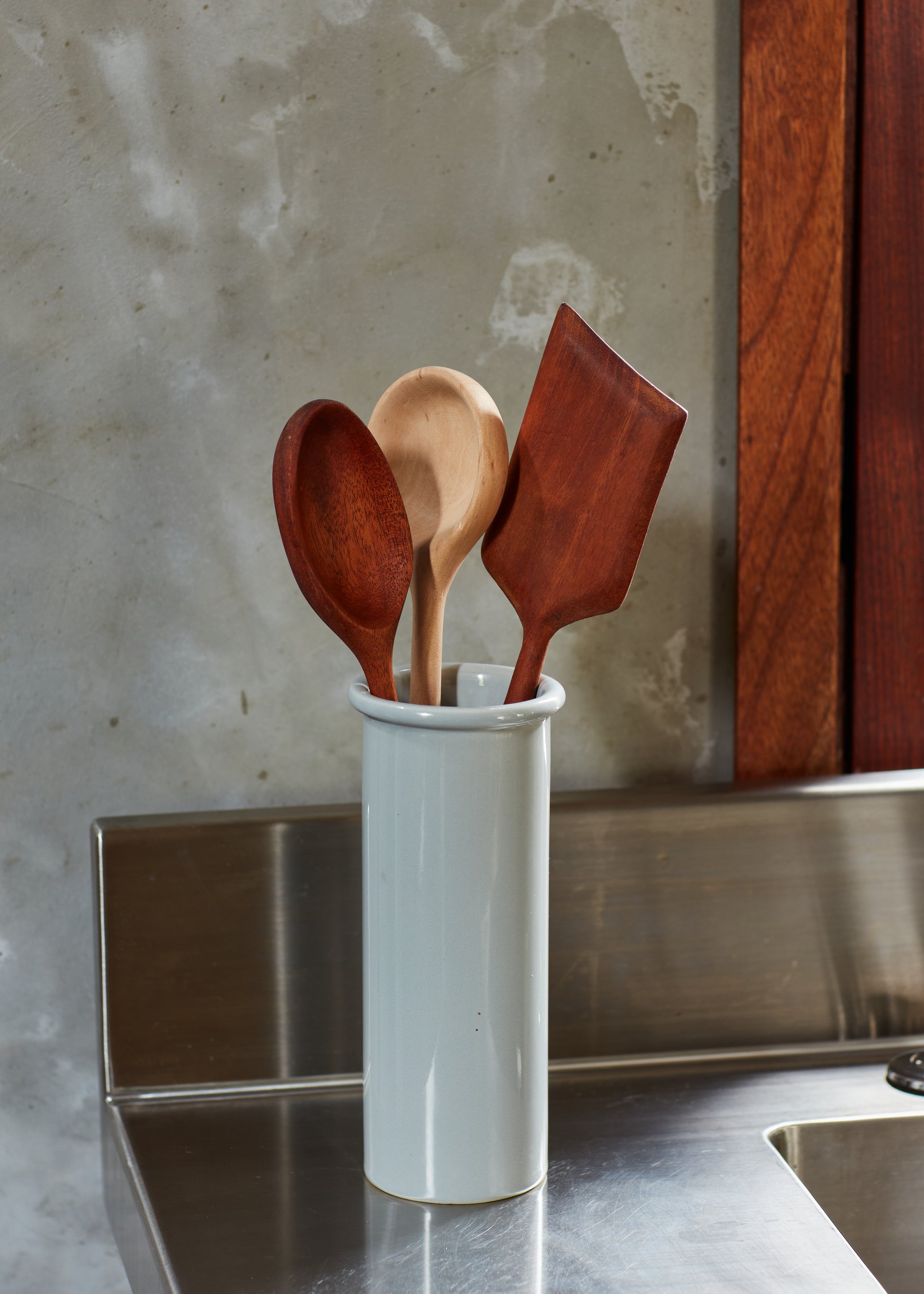 Finished cooking spoons and spatula shown on kitchen counter. By Melanie Abrantes Designs.