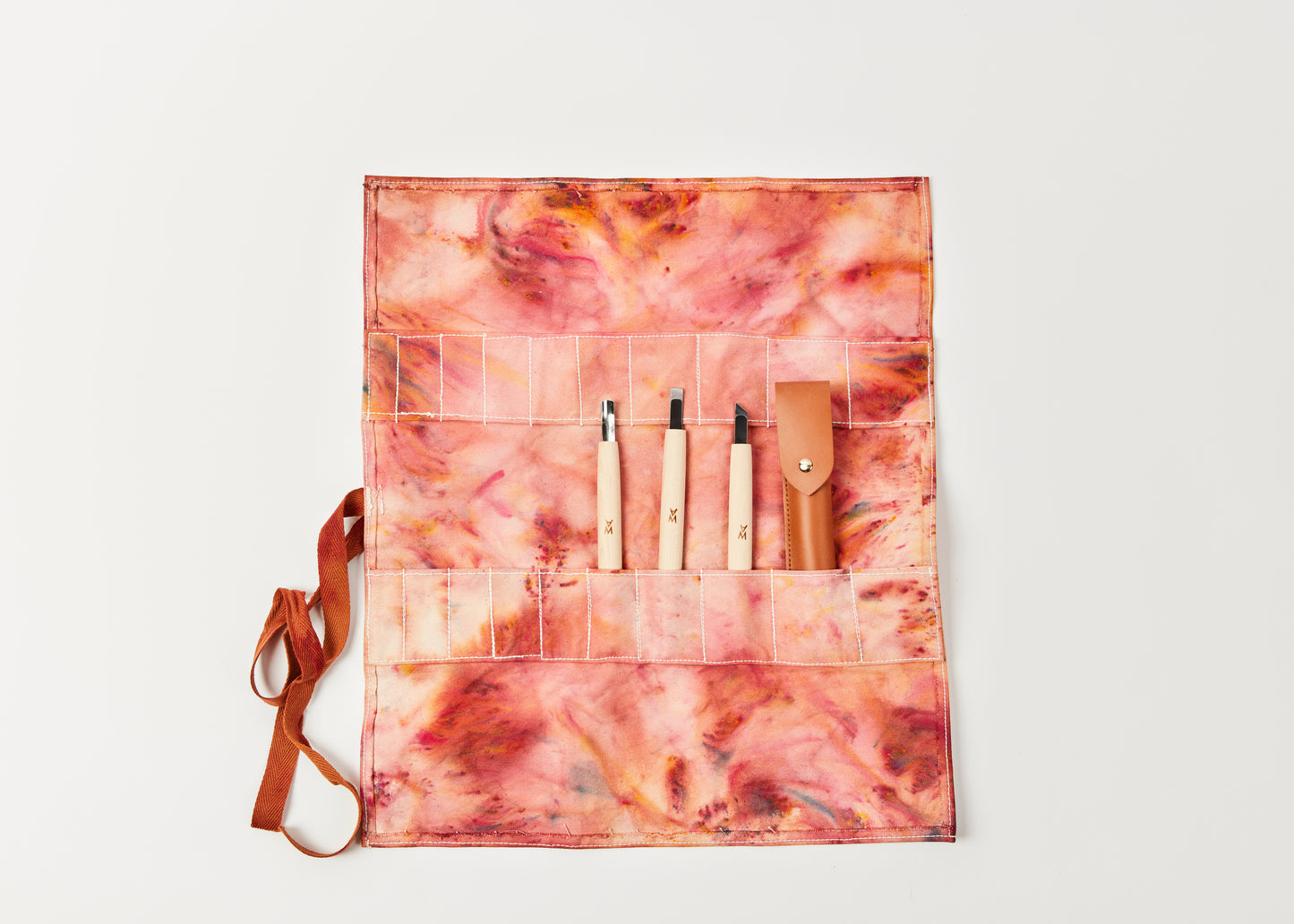 Crimson colored limited edition hand-dyed tool roll. Displayed open with carving tools | Melanie Abrantes Designs
