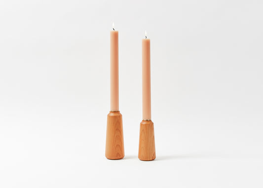 Cherry Hardwood Candle Holders and a set of Fancy Tapered Candles in petal by The Floral Society. 
