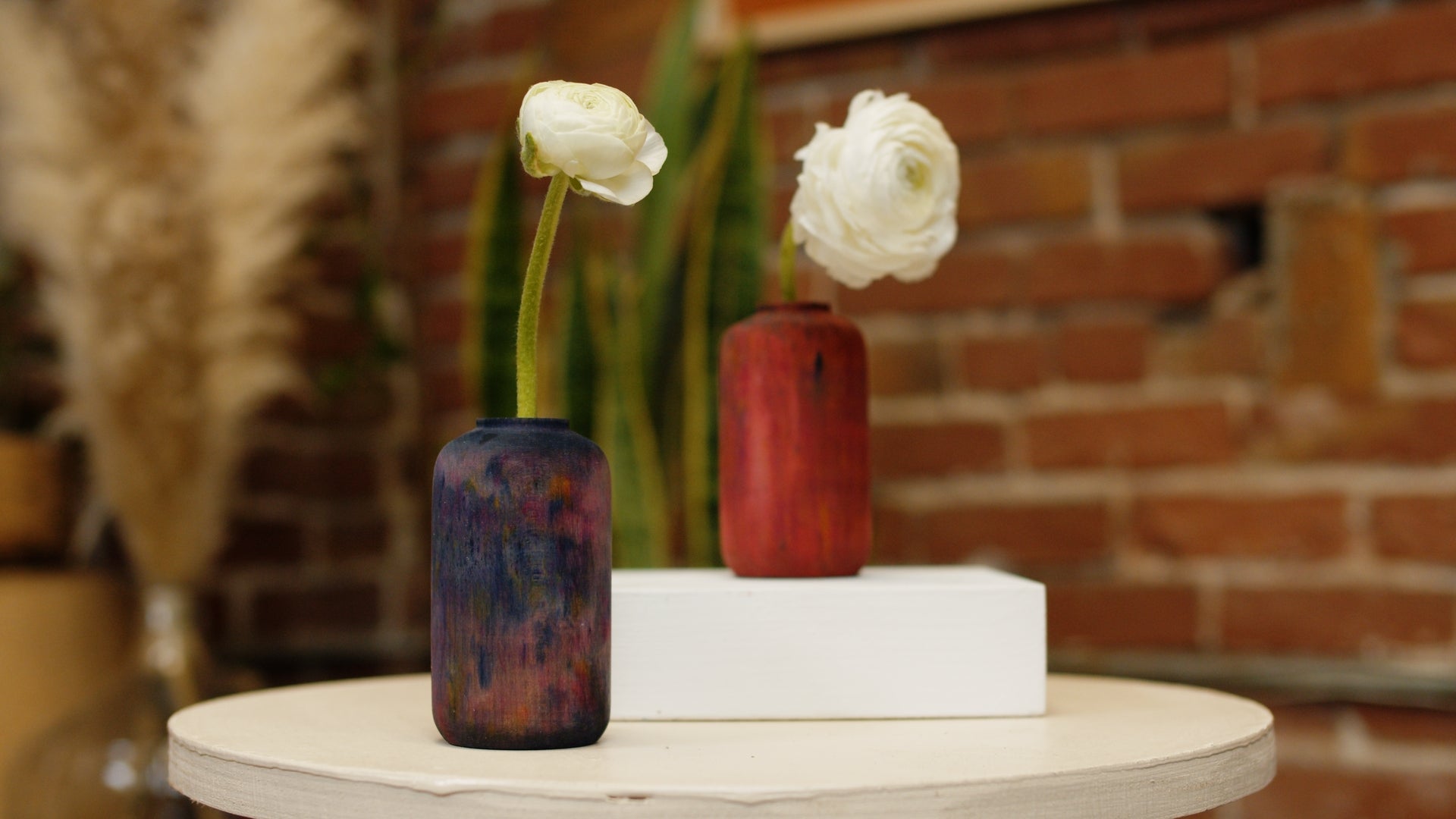 Our small maple vases dyed with our ice dye. Both midnight and crimson shown with a single white flower in each vase. By Melanie Abrantes Designs.