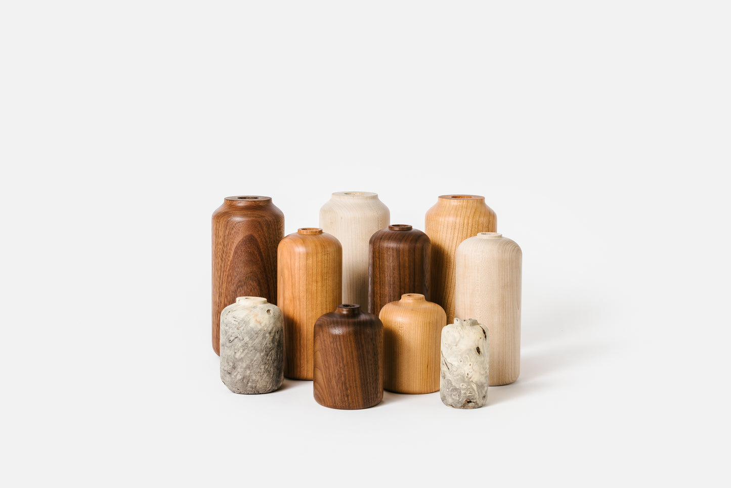 Collection of wooden vases in varying styles and materials.