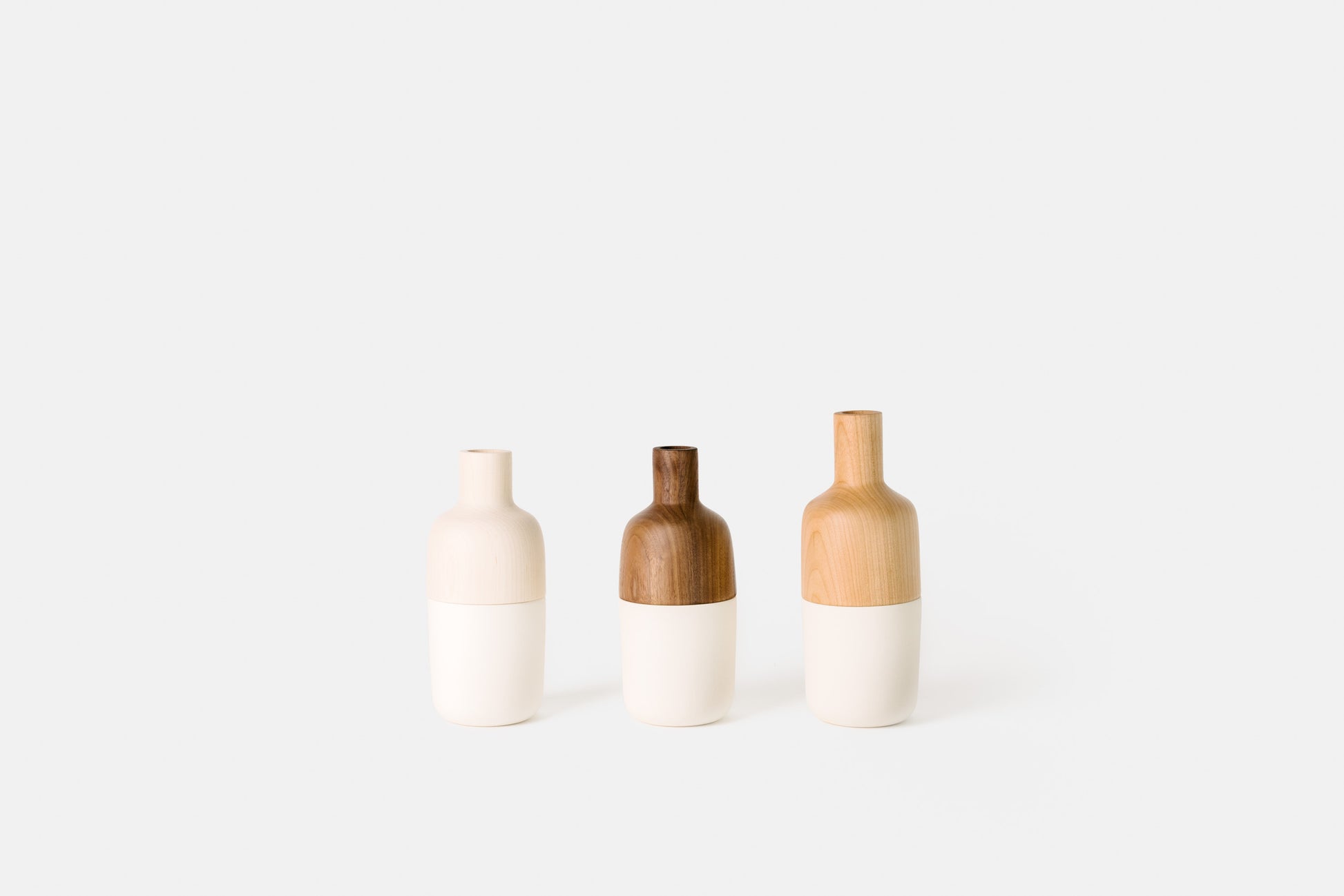 Hardwood and white ceramic marais vases by Melanie Abrantes Designs.