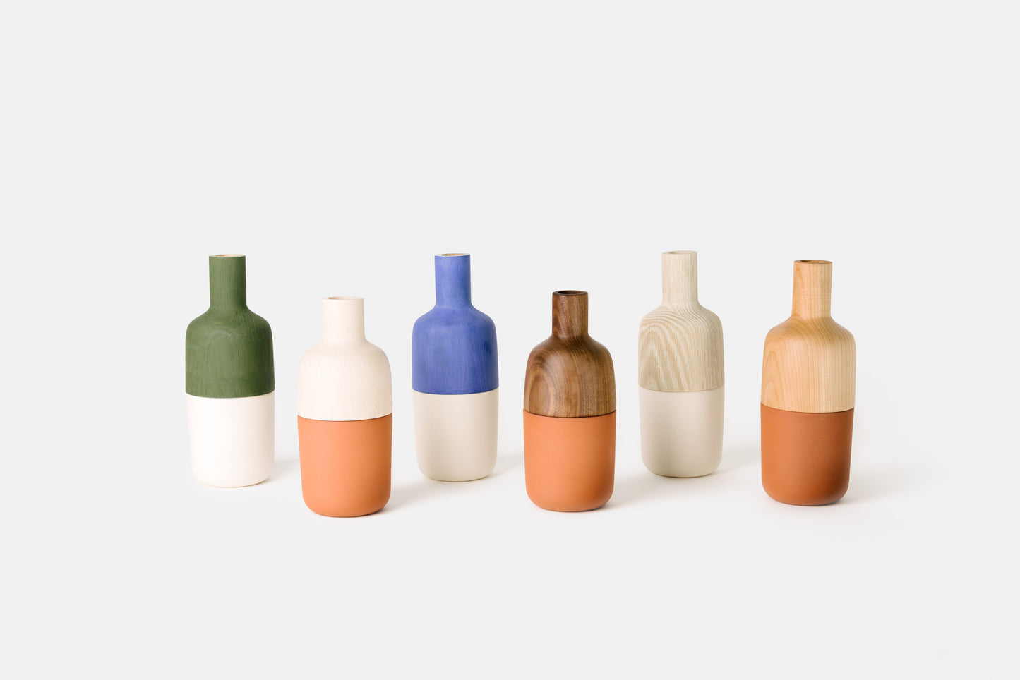 Mix of hardwood and ceramic marais vases by Melanie Abrantes Designs.