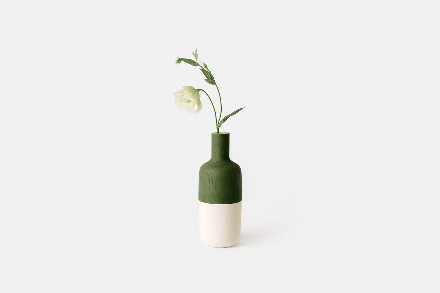 Painted green oak marais vase with white ceramic bottom.