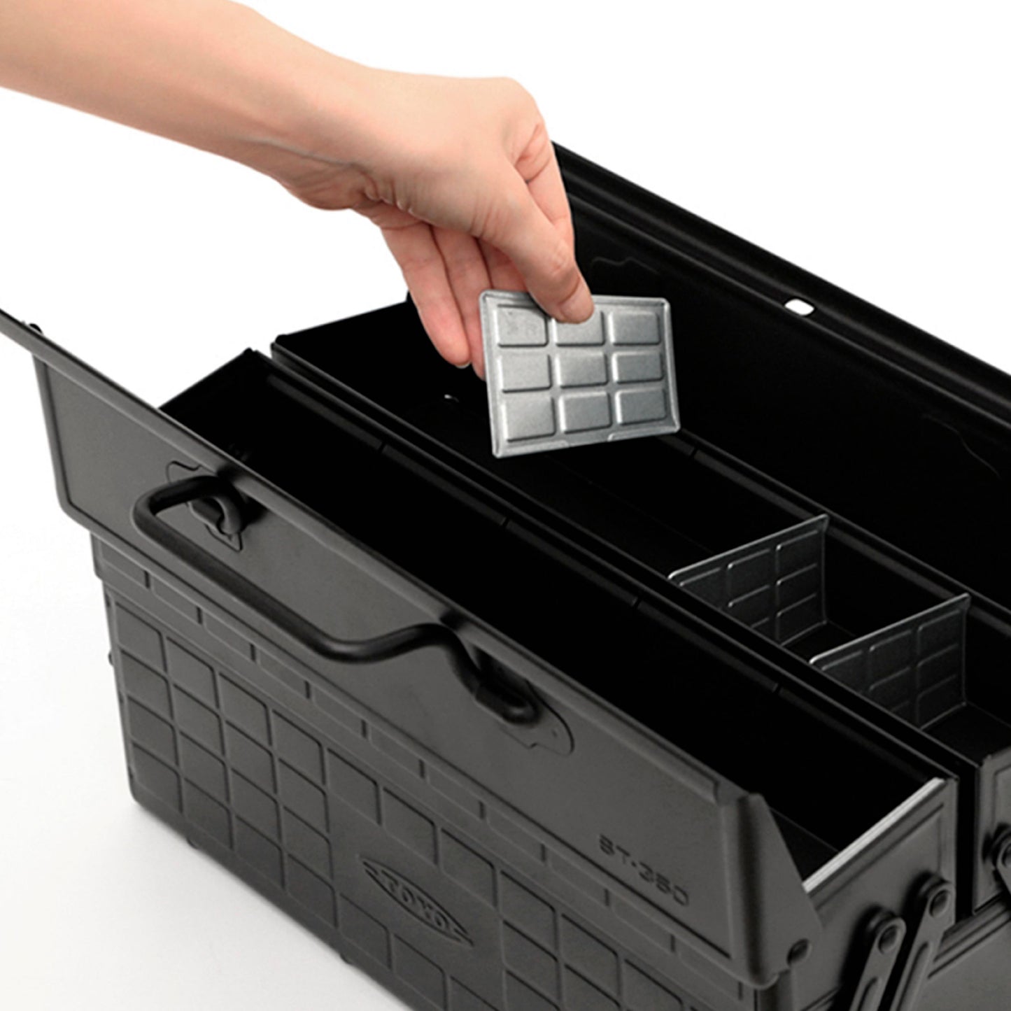 Person arranging compartments in the Japanese Steel Tool Box in Black by Toyo